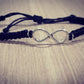 Pulsera tejida negra con simbolo de infinito
